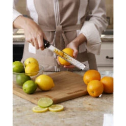Microplane Premium Classic Zester/Grater -Professional Kitchen Tool Store MP46020 Microplane Grater Zester Zesting Oranges Back View